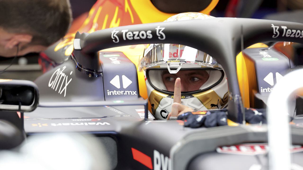Red Bull driver Max Verstappen speaks with a member of his crew as he sits in his car prior to the first practice session ahead of the Formula One Grand Prix at the Spa-Francorchamps racetrack in Spa, Belgium, Friday, Aug. 26, 2022. The Belgian Formula One Grand Prix will take place on Sunday. (AP/Olivier Matthys)