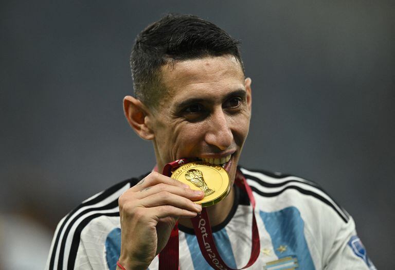 Soccer Football - FIFA World Cup Qatar 2022 - Final - Argentina v France - Lusail Stadium, Lusail, Qatar - December 18, 2022  Argentina's Angel Di Maria celebrates with a medal after winning the World Cup REUTERS/Dylan Martinez