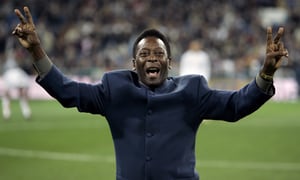 FILE - Brazil's soccer legend Pele greets the crowd ahead of a Spanish league soccer match, in the Santiago Bernabeu stadium in Madrid, Jan. 16, 2005. Pelé, the Brazilian king of soccer who won a record three World Cups and became one of the most commanding sports figures of the last century, died in Sao Paulo on Thursday, Dec. 29, 2022. He was 82. (AP Photo/Jasper Juinen, File)