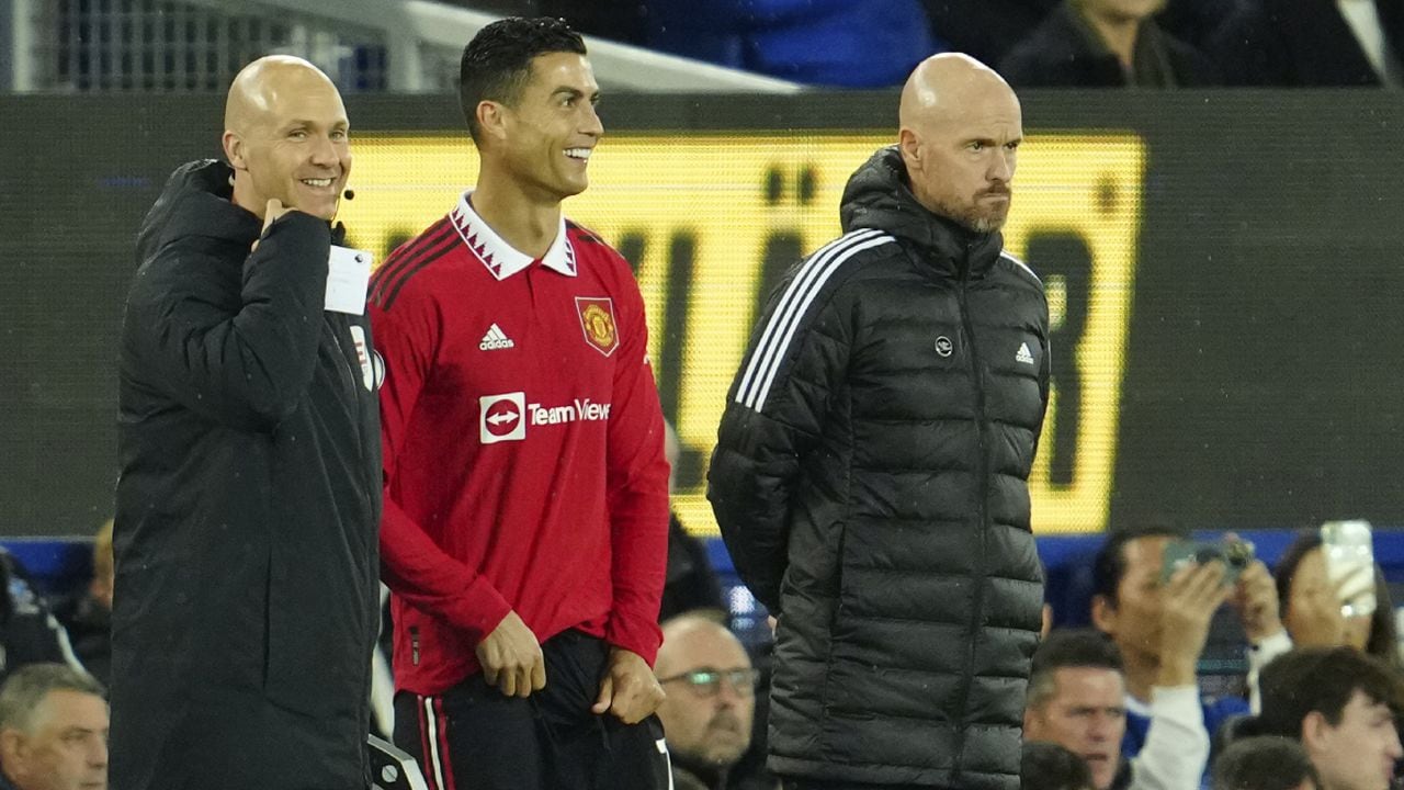 Manchester United's Cristiano Ronaldo stands next to Manchester United's head coach Erik ten Hag, right, waiting to replace teammate Anthony Martial during the Premier League soccer match between Everton and Manchester United at Goodison Park, in Liverpool, England, Sunday Oct. 9, 2022. (AP/Jon Super)
