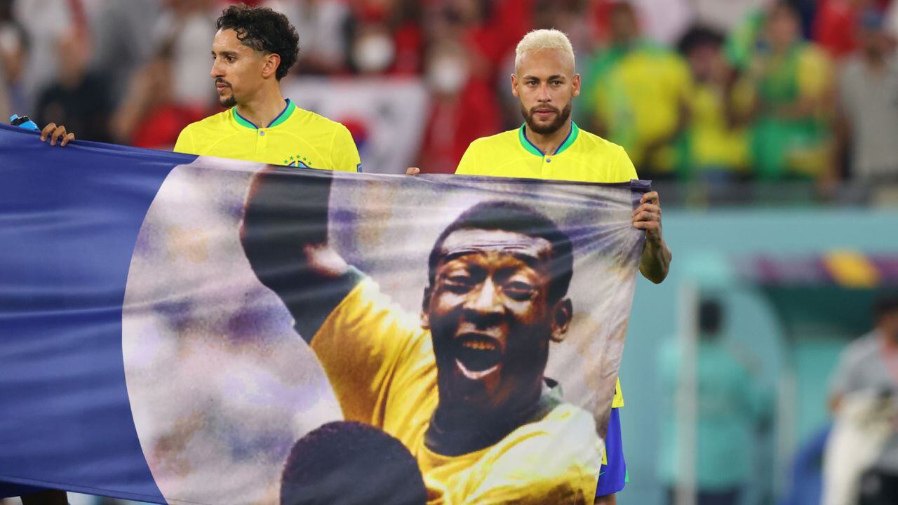 DOHA, QATAR - DECEMBER 05 Brazil's Neymar and Marquinhos hold a banner in support of former Brazil player Pele after the FIFA World Cup Qatar 2022 Round of 16 match between Brazil and South Korea at Stadium 974 on December 5, 2022 in Doha, Qatar. (Photo by Getty Images/Marc Atkins)