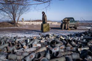 Un miembro de la tripulación de un helicóptero de la 18.ª Brigada de Aviación del Ejército Separado lleva cajas de municiones en el este de Ucrania el 9 de febrero de 2023 en medio de la invasión militar de Rusia en Ucrania. (Foto de Ihor Tkachov / AFP)
