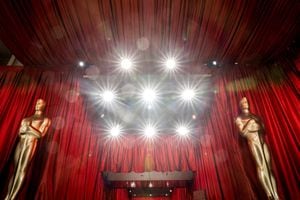 Estatuas decorativas de los Óscar se encuentran cerca de focos y cortinas rojas mientras se realizan los preparativos finales para la 95.ª entrega de los Premios de la Academia, en Hollywood, Los Ángeles, California, el 11 de marzo de 2023. (Foto de Stefani Reynolds / AFP)