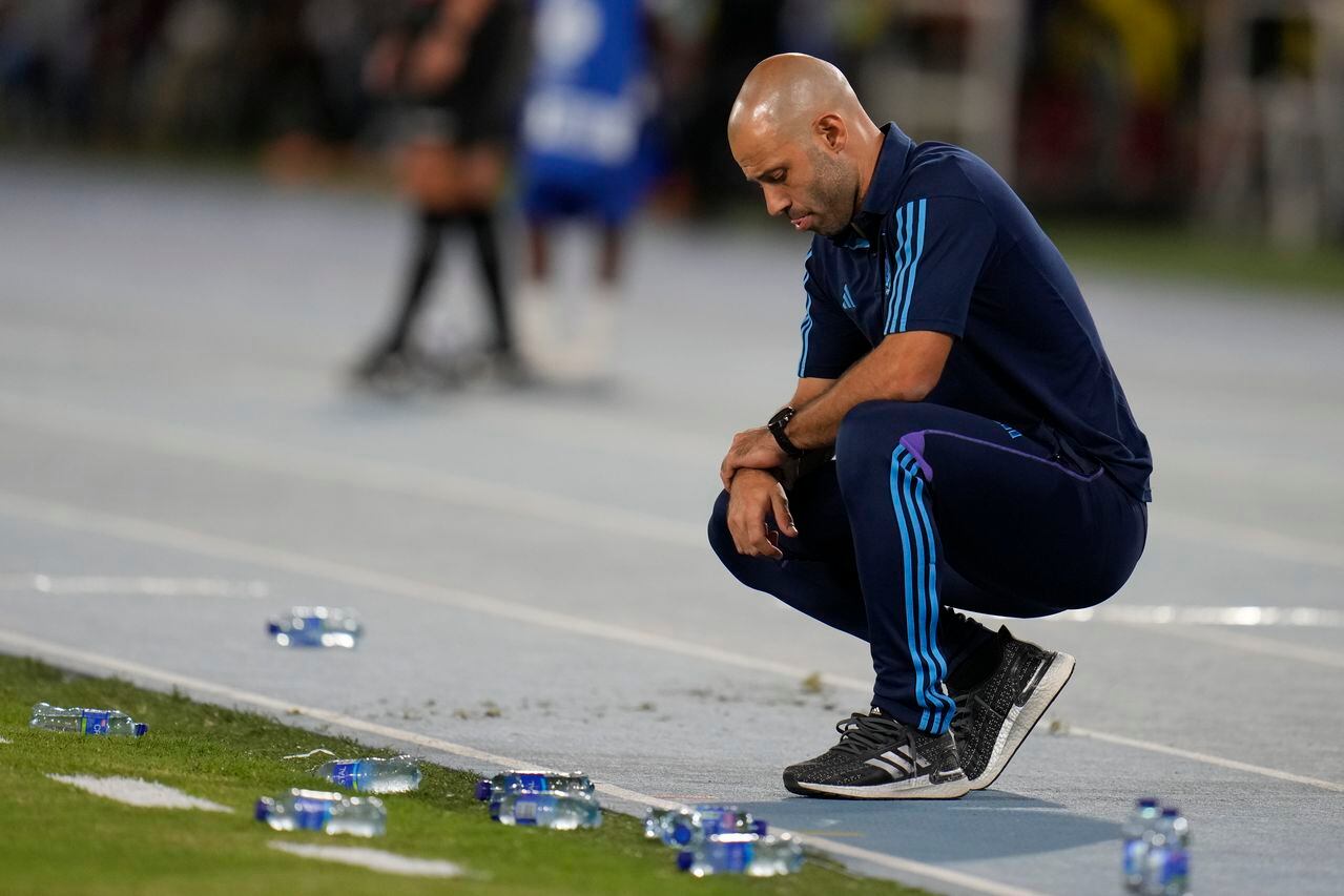 Argentina's coach Javier Mascherano squats on the sideline during his team's South America U-20 Championship soccer match against Colombia in Cali, Colombia, Friday, Jan. 27, 2023. (AP Photo/Fernando Vergara)