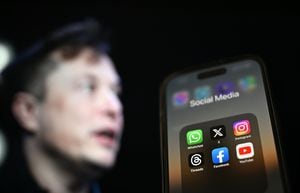 ANKARA, TURKIYE - JULY 30: In this photo illustration, the logos of various social media apps including 'X' (formerly known as Twitter) are displayed on a phone screen in front of a screen displaying the picture of Elon Musk in Ankara, Turkiye on July 30, 2023. (Photo by Aytug Can Sencar/Anadolu Agency via Getty Images)