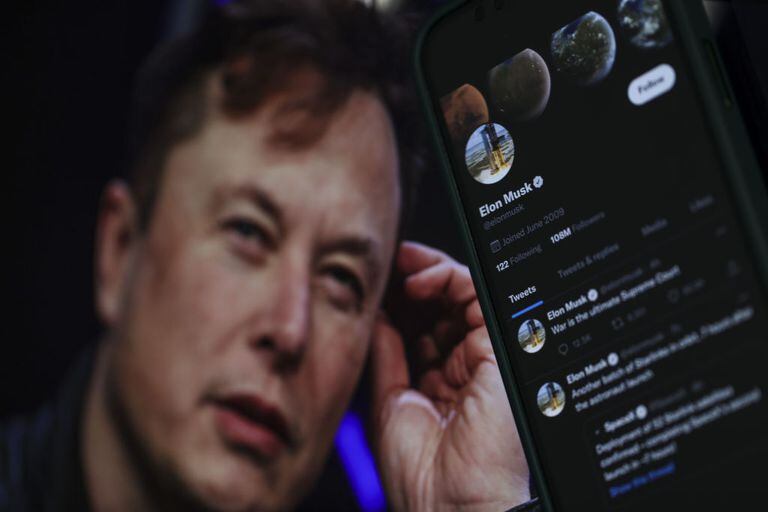 En esta ilustración fotográfica, el perfil de Twitter de Elon Musk se muestra en un teléfono móvil y su imagen se ve en la pantalla de una computadora en la parte posterior en Ankara, Turkiye, el 6 de octubre de 2022. Muhammed Selim Korkutata / Agencia Anadolu