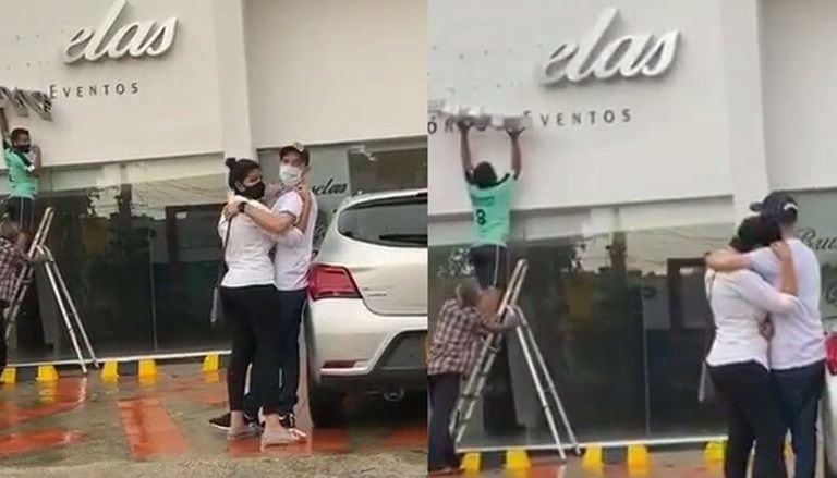 La imagen de Tovar y Roncallo abrazados mientras un trabajador desmonta el aviso de su negocio se hizo viral en redes sociales.