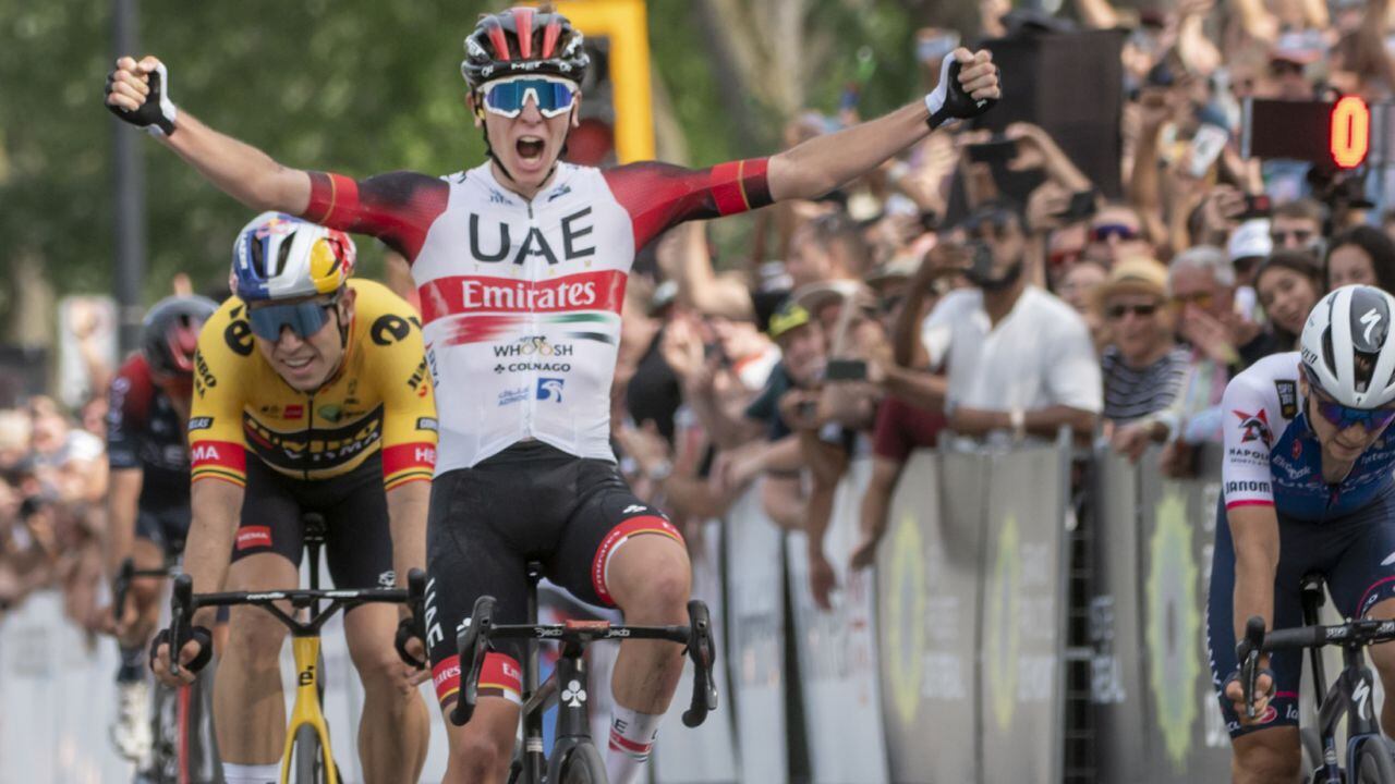 Tadej Pogacar, front left,of UAE Team Emirates, celebrates as he crosses the finish line with his first-place finish at the Grand Prix Cycliste de Quebec bicycle race Sunday, Sept. 11, 2022. (AP/Peter McCabe/The Canadian Press)