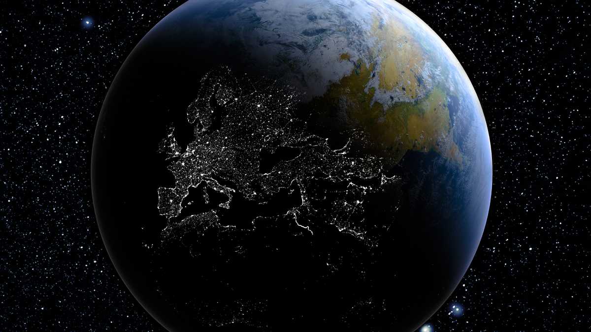 Tierra desde el espacio que muestra el efecto del día en la noche con las luces de la ciudad que se muestran en el lado oscuro
