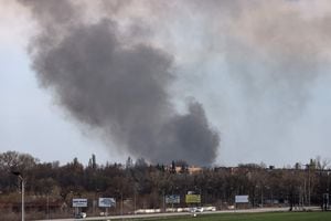 Smoke raises from the airport of Dnipro, on April 10, 2022, amid Russian invasion of Ukraine (Photo by RONALDO SCHEMIDT / AFP)