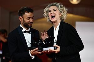 Enrico Maria Artale and Margarita Rosa De Francisco pose with the Best Screenplay Award for film 'El Paraiso' and the award for Best Actress for film 'El Paraiso' during a photocall at the 80th Venice Film Festival on September 9, 2023 at Venice Lido. (Photo by GABRIEL BOUYS / AFP)
