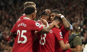 Manchester United's Marcus Rashford celebrates with his teammates after scoring his side's second goal during the English Premier League soccer match between Manchester United and Liverpool at Old Trafford stadium, in Manchester, England, Monday, Aug 22, 2022. (AP Photo/Dave Thompson)