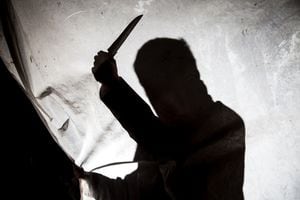 Silhouette of killer with knife in action