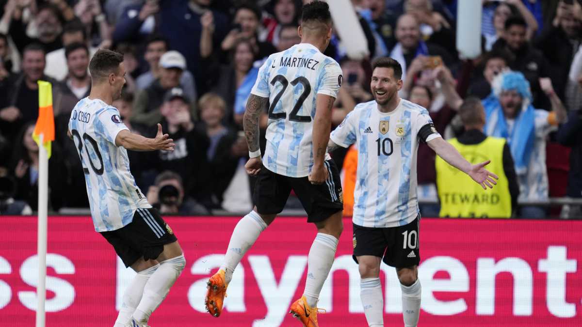 Argentina's Lautaro Martinez, center, celebrates with his teammates Lionel Messi, right, and Giovani Lo Celso after scoring his side's opening goal during the Finalissima soccer match between Italy and Argentina at Wembley Stadium in London , Wednesday, June 1, 2022. (AP/Matt Dunham)