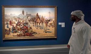 Un hombre emiratí, con una máscara protectora debido a la pandemia de COVID-19, visita el Museo de Arte de Sharjah el 24 de agosto de 2020. - Desde creaciones que representan el asesinato de palestinos hasta la vida cotidiana de quienes vivían en la ciudad vieja de Sanaa en Yemen, pinturas de artistas árabes cobran vida en el emirato de Sharjah en el Golfo. Sharjah es uno de los siete emiratos que conforman los Emiratos Árabes Unidos, cuya capital, Abu Dhabi, y el libre Dubai son más conocidos por sus hoteles ultra lujosos, mega centros comerciales y eventos globales. En los últimos años, los Emiratos Árabes Unidos han invertido enormes sumas en la cultura, incluido el Louvre Abu Dhabi, una sucursal del museo de París que se inauguró en 2017 (Foto de Karim SAHIB / AFP).