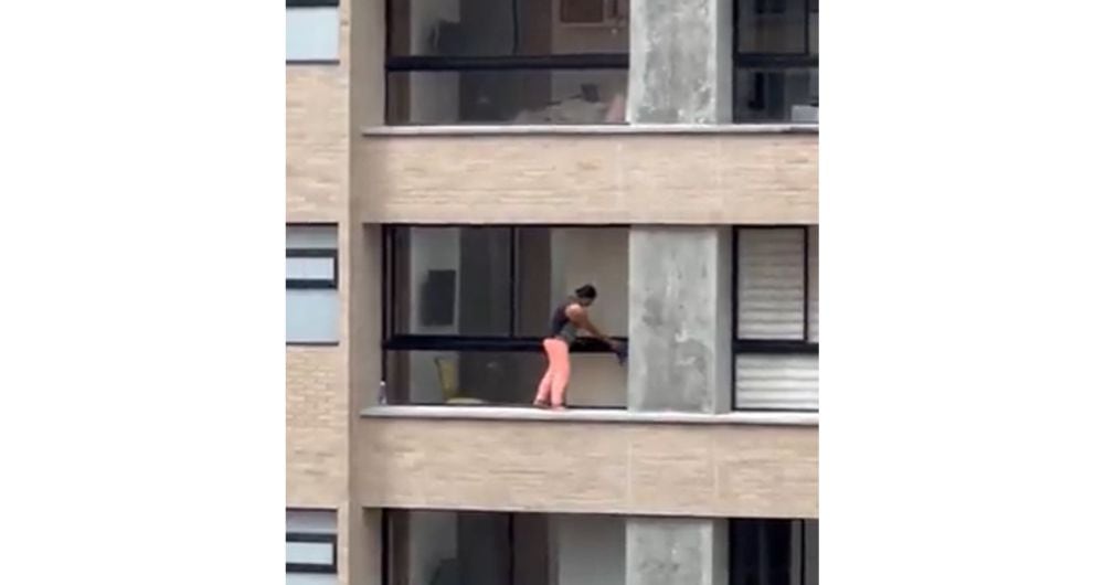 Video de mujer limpiando desde un piso doce ventanas sin contar con protección.