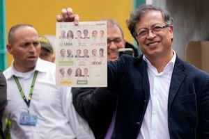 Gustavo Petro, presidential candidate with the Historical Pact coalition, shows his ballot before voting during presidential elections in Bogota, Colombia, Sunday, May 29, 2022. (AP Photo/Fernando Vergara)
