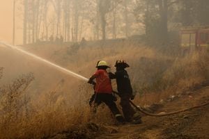 Bomberos trabajan durante un incendio forestal en Quillón, Chile, 9 de febrero de 2023. 
