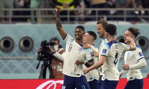 England's Marcus Rashford celebrates with teammates after scoring his side's fifth goal during the World Cup group B soccer match between England and Iran at the Khalifa International Stadium in Doha, Qatar, Monday, Nov. 21, 2022. (AP Photo/Frank Augstein)