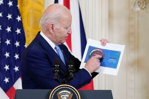 President Joe Biden holds a paper showing an air quality level for Washington as he speaks about Canada's wildfires during a news conference with British Prime Minister Rishi Sunak in the East Room of the White House in Washington, Thursday, June 8, 2023. (AP Photo/Manuel Balce Ceneta)