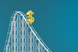 computer generated image of a dollar sign on a rollercoaster track on a blue background. Dollar value decreasing concept illustration.