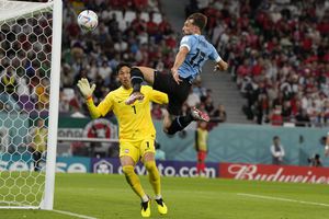 Uruguay's Matias Vina jumps for a ball in an attempt to score against South Korea's goalkeeper Kim Seung-gyu during the World Cup group H soccer match between Uruguay and South Korea, at the Education City Stadium in Al Rayyan , Qatar, Thursday, Nov. 24, 2022. 