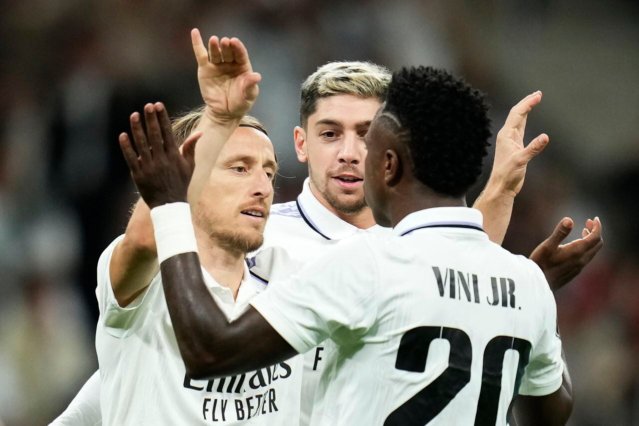 Real Madrid's Luka Modric, left, celebrates with teammates after scoring his side's first goal during the Champions League Group F soccer match between Real Madrid and Celtic at the Santiago Bernabeu stadium in Madrid, Spain, Wednesday, Nov. 2, 2022. (AP Photo/Manu Fernandez)