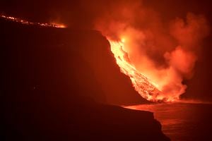Lava de un volcán en erupción en la isla de La Palma llega al Océano Atlántico, en las Islas Canarias, en la madrugada del 29 de septiembre de 2021. Foto AP / Saúl Santos.