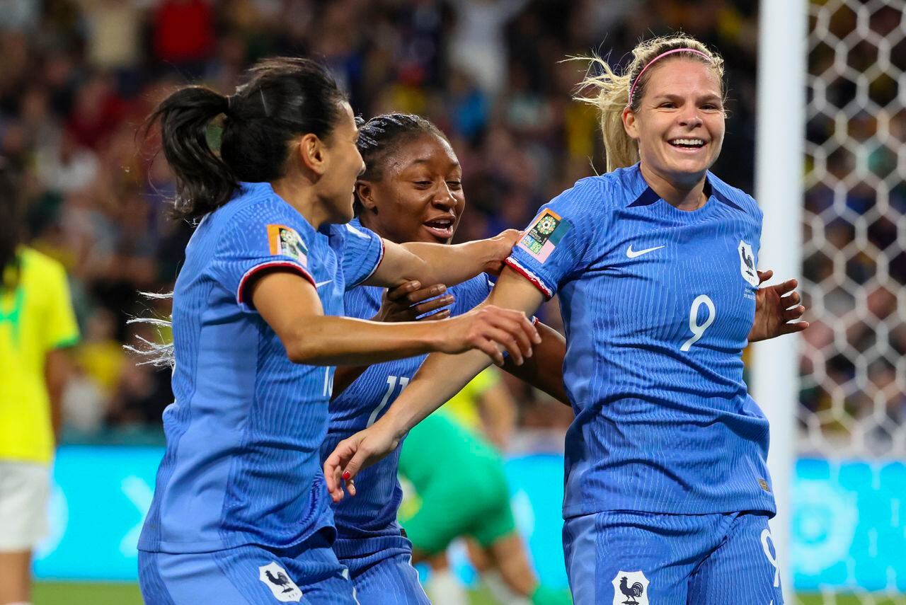 France's Eugenie Le Sommer, right, is congratulated by teammate's Kenza Dali, left, and Kadidiatou Diani after scoring their first goal during the Women's World Cup Group F soccer match between France and Brazil in Brisbane, Australia, Saturday, July 29, 2023. (AP Photo/Tertius Pickard)