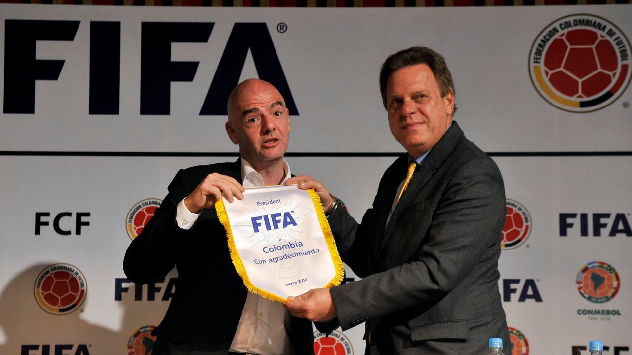BOGOTA, COLOMBIA - MARCH 31: FIFA President Gianni Infantino (L) gives a present to Colombian Futbol Federation President Ramon Jesurum (R) during a press conference as part of FIFA President Gianni Infantino's visit to South America on March 31, 2016 in Bogota, Colombia. (Photo by Gal Schweizer/LatinContent via Getty Images)