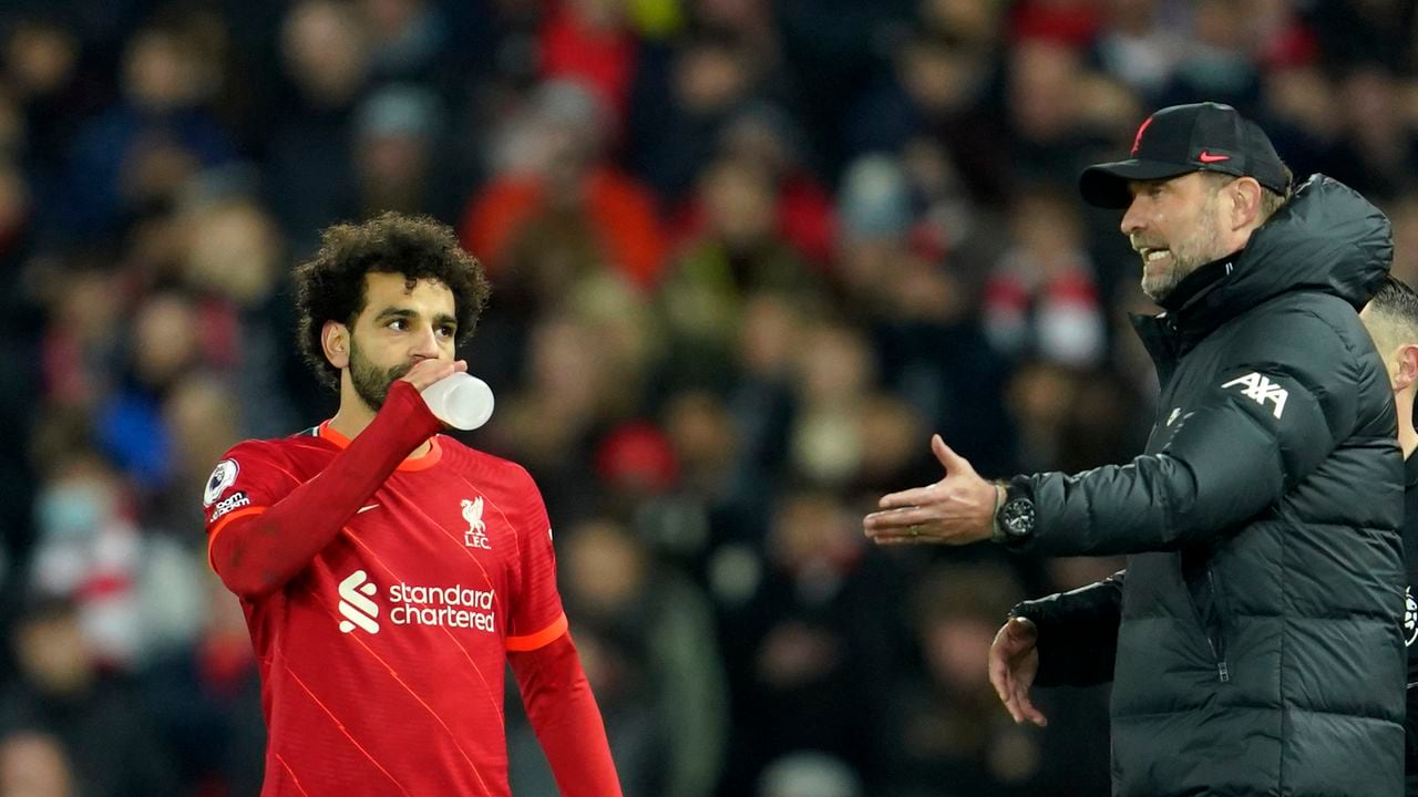 Liverpool's manager Jurgen Klopp, right, gives instructions to Liverpool's Mohamed Salah during the English Premier League soccer match between Liverpool and Newcastle United at Anfield stadium in Liverpool, England, Thursday, Dec. 16, 2021. (AP Photo/Jon Super)