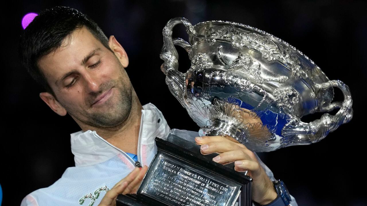 Novak Djokovic of Serbia holds the Norman Brookes Challenge Cup after defeating Stefanos Tsitsipas of Greece in the men's singles final at the Australian Open tennis championship in Melbourne, Australia, Sunday, Jan. 29, 2023.(AP Photo/Dita Alangkara)