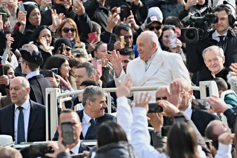 Pope Francis greets the crowd as he arrives for his general audience in St. Peter Square at the Vatican on March 13, 2024. (Photo by Andreas SOLARO / AFP)