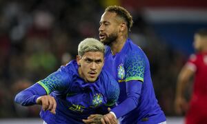 Brazil's Pedro is congratulated by teammate Neymar after scoring his team fifth goal during the international friendly soccer match between Brazil and Tunisia at the Parc des Princes stadium in Paris, France, Tuesday, Sept. 27, 2022. (AP Photo/Christophe Ena)