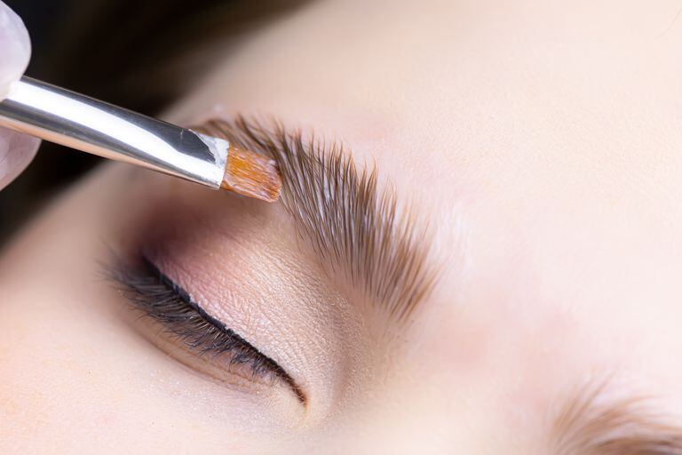close-up of the procedure for long-term eyebrow styling, the master performs eyebrow lamination