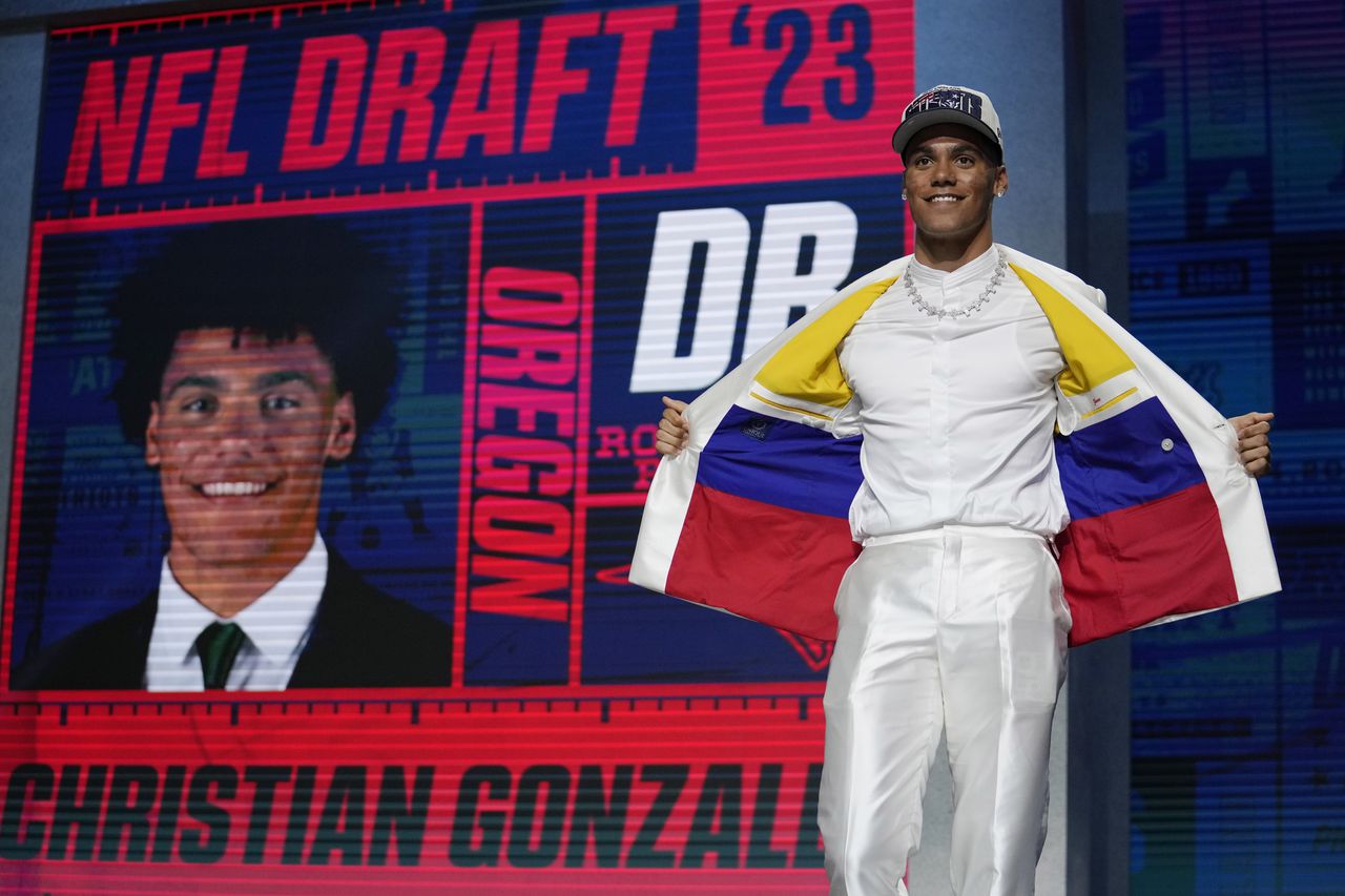 Oregon defensive back Christian Gonzalez stands on stage after being chosen by the New England Patriots with the 17th overall pick during the first round of the NFL football draft, Thursday, April 27, 2023, in Kansas City, Mo. (AP Photo/Jeff Roberson)
