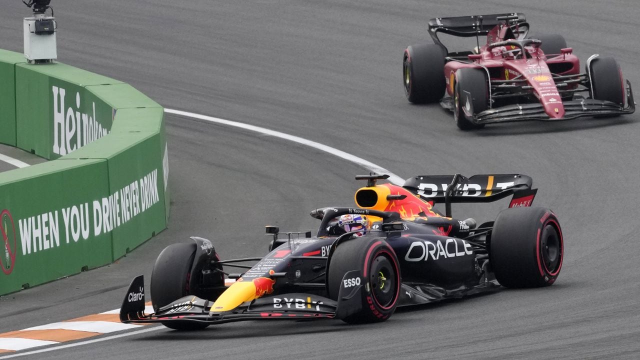 Red Bull driver Max Verstappen of the Netherlands leads Ferrari driver Charles Leclerc of Monaco, right, during the Formula One Dutch Grand Prix auto race, at the Zandvoort racetrack, in Zandvoort, Netherlands, Sunday, Sept. 4, 2022. (AP/Peter Dejong)