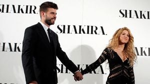FILE PHOTO: Colombian singer Shakira and Barcelona's soccer player Gerard Pique (L) pose during a photocall presenting her new album "Shakira" in Barcelona March 20, 2014. REUTERS/Albert Gea/File Photo