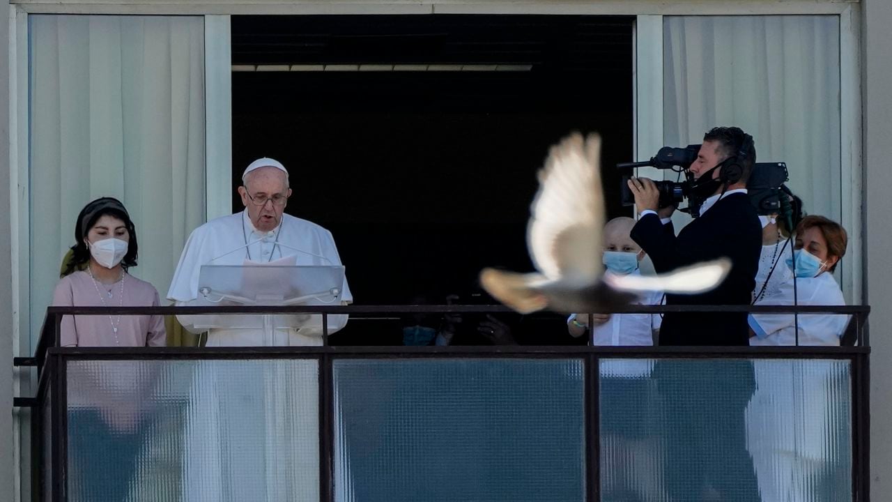 Pope Francis appears on a balcony of the Agostino Gemelli Polyclinic in Rome, Sunday, July 11, 2021, where he is recovering from intestinal surgery, for the traditional Sunday blessing and Angelus prayer. Pope Francis is 84 and had a part of his colon removed a week ago. (AP Photo/Alessandra Tarantino)