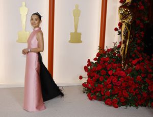 Hong Chau poses on the champagne-colored red carpet during the Oscars arrivals at the 95th Academy Awards in Hollywood, Los Angeles, California, U.S., March 12, 2023. REUTERS/Eric Gaillard
