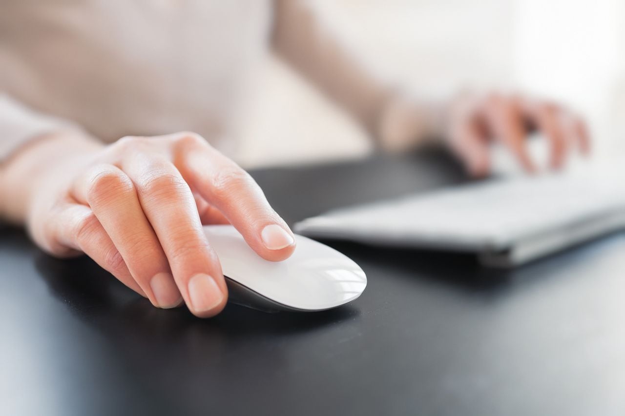 Close-up of female hand with computer mouse. Shallow DOF.