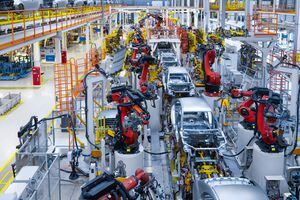 Producción de línea de montaje de coche nuevo. Soldadura automatizada de carrocerías en línea de producción. El brazo robótico en la línea de producción de automóviles está funcionando.