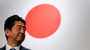 FILE PHOTO: Japan's Prime Minister Shinzo Abe stands in front of Japan's national flag after his ruling Liberal Democratic Party's (LDP) annual party convention in Tokyo, Japan, March 5, 2017.  REUTERS/Toru Hanai/File Photo