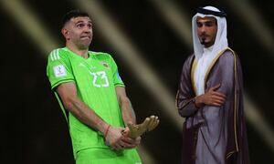 Soccer Football - FIFA World Cup Qatar 2022 - Final - Argentina v France - Lusail Stadium, Lusail, Qatar - December 18, 2022 Argentina's Emiliano Martinez reacts after receiving the Golden Glove award after the match REUTERS/Kai Pfaffenbach TPX IMAGES OF THE DAY