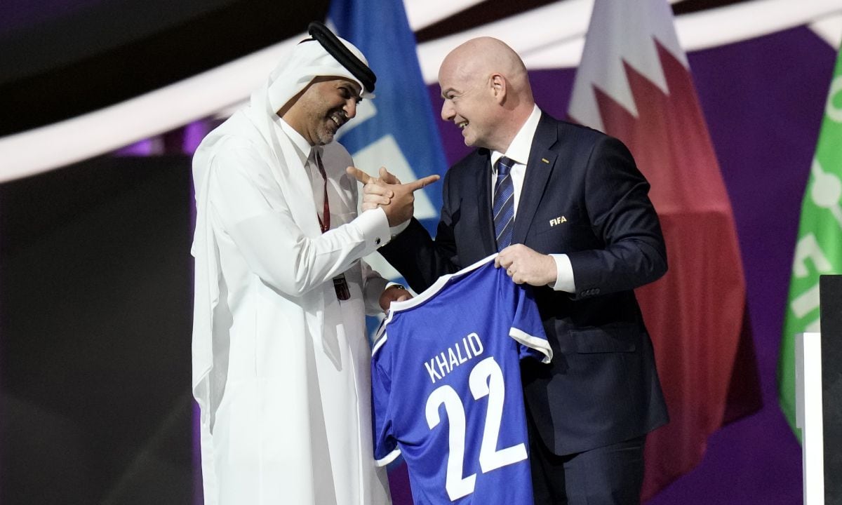 Prime Minister of the State of Qatar, Khalid Bin Khalifa Bin Abdulaziz Al Thani, left, receives a gift from FIFA President Gianni Infantino during the FIFA congress at the Doha Exhibition and Convention Center in Doha, Qatar, Thursday, March 31, 2022. (AP/Hassan Ammar)
