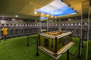 View of the mausoleum where the coffin of late Brazilian football star Pele rests, at the Ecumenical Necropolis Memorial cemetery in Santos, Brazil on May 15, 2023. In the 200 m� space, which was opened for visitation today, the public will be able to see a simulation of Santos' fans on the walls, the floor with synthetic grass and a bluish ceiling above the tomb, which is golden and has images of remarkable moments of the career of the Athlete of the Century, who died at the age of 82 on December 29, 2022. (Photo by NELSON ALMEIDA / AFP)