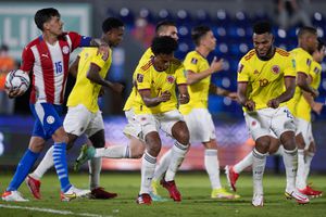Colombia's Juan Cuadrad, left, celebrates with teammate Miguel Borja after scoring from the penalty spot his side's opening goal against Paraguay during a qualifying soccer match for the FIFA World Cup Qatar 2022 in Asuncion, Paraguay, Sunday, Sept. 5, 2021. (AP Photo/Jorge Saenz)
