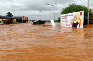 A billboard with a photograph of Prime Minister Narendra Modi is partially submerged in flood waters at Kolhapur in western Maharashtra state, India, Saturday, July 24, 2021. Officials say landslides and flooding triggered by heavy monsoon rain have killed more than 100 people in western India. More than 1,000 people trapped by floodwaters have been rescued. (AP Photo)