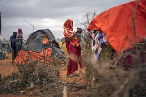 FILE - A Somali woman breastfeeds her child at a camp for displaced people on the outskirts of Dollow, Somalia on Tuesday, Sept. 20, 2022. A new report says an estimated 43,000 people died amid the longest drought on record in Somalia last year and half of them likely were children.. (AP Photo/Jerome Delay, File)