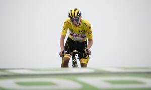 Slovenia's Tadej Pogacar, wearing the overall leader's yellow jersey, crosses the finish line to win the seventeenth stage of the Tour de France cycling race over 178.4 kilometers (110.9 miles) with start in Muret and finish in Saint-Lary-Soulan Col du Portet, France, Wednesday, July 14, 2021. (AP Photo/Christophe Ena)